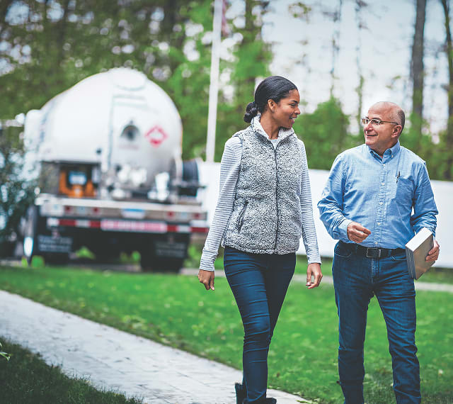 People walking by propane truck